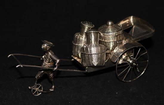 A sterling silver cruet set modelled as a rickshaw.